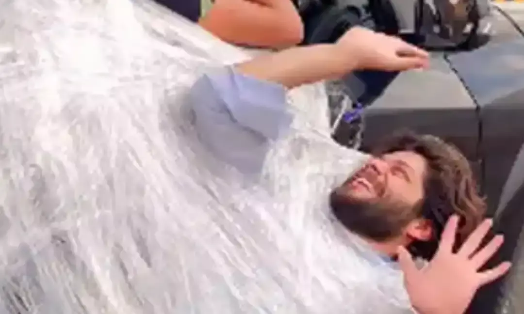 Man Hangs On Car Door To Sleep